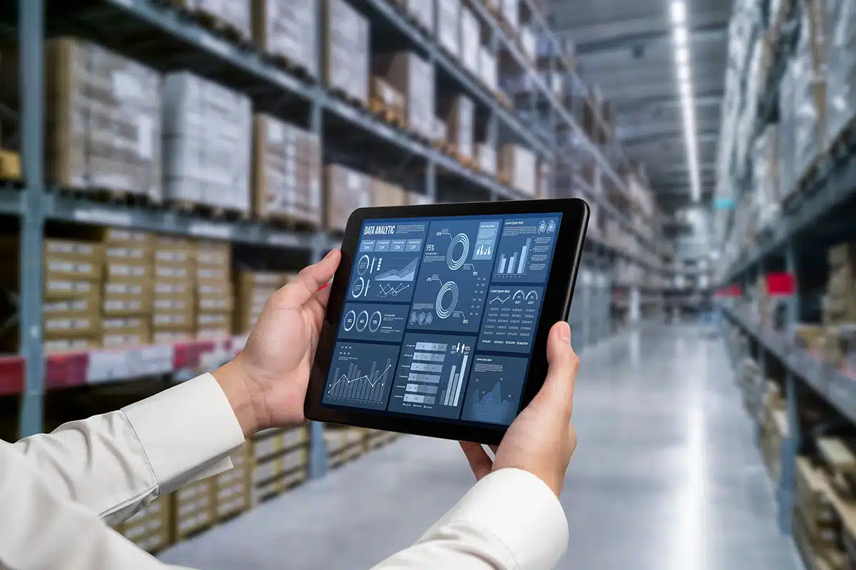 Photo of a worker in an electronics factory using a mobile data device.